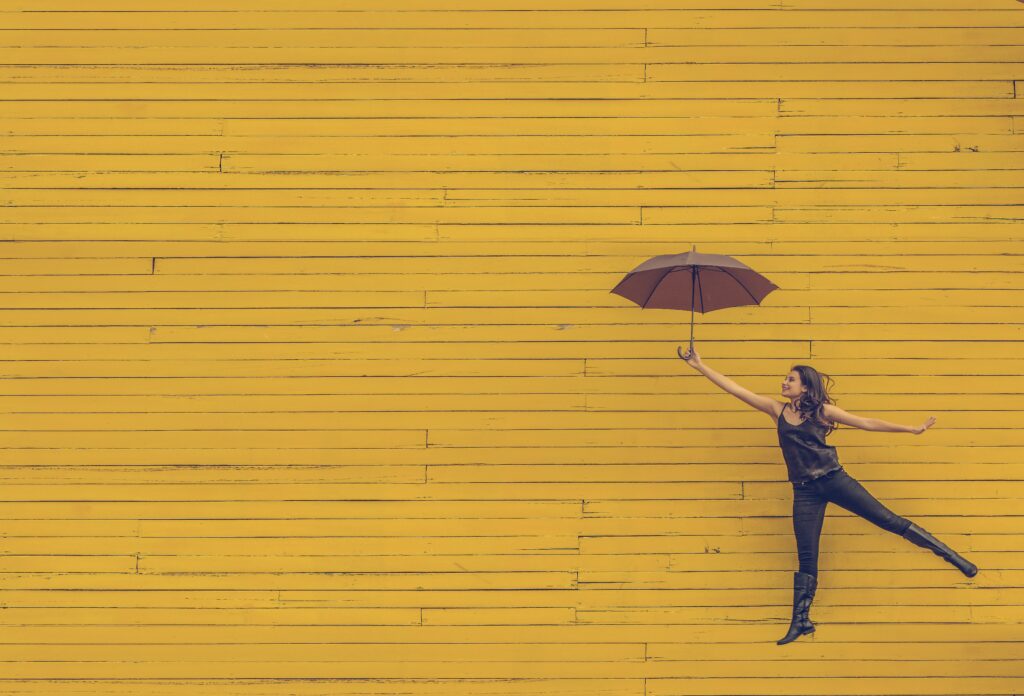 Woman jumping with umbrella