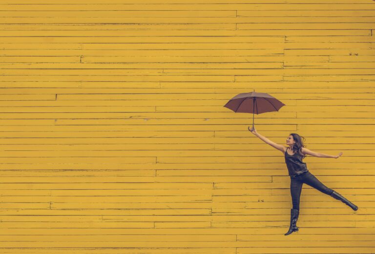 Woman jumping with umbrella