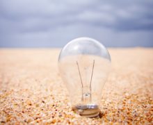 Lightbulb in sand