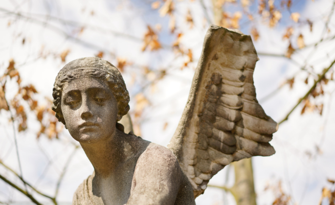 A statue of a person with broken wing