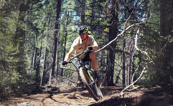 Stu in a mountain bike driving in the forest
