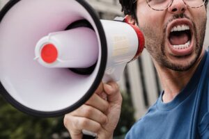 Amplify your message - Man talking into megaphone