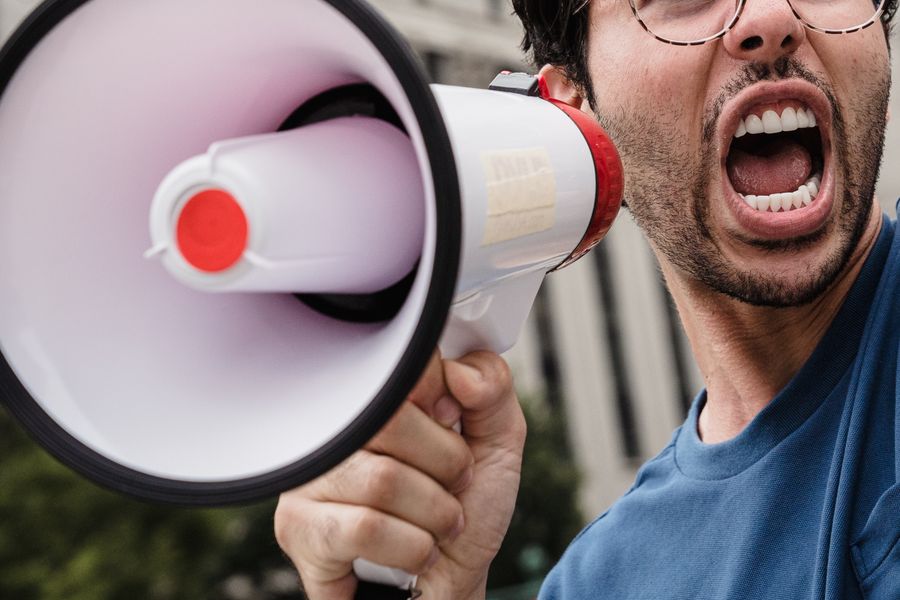 Amplify your message - Man talking into megaphone